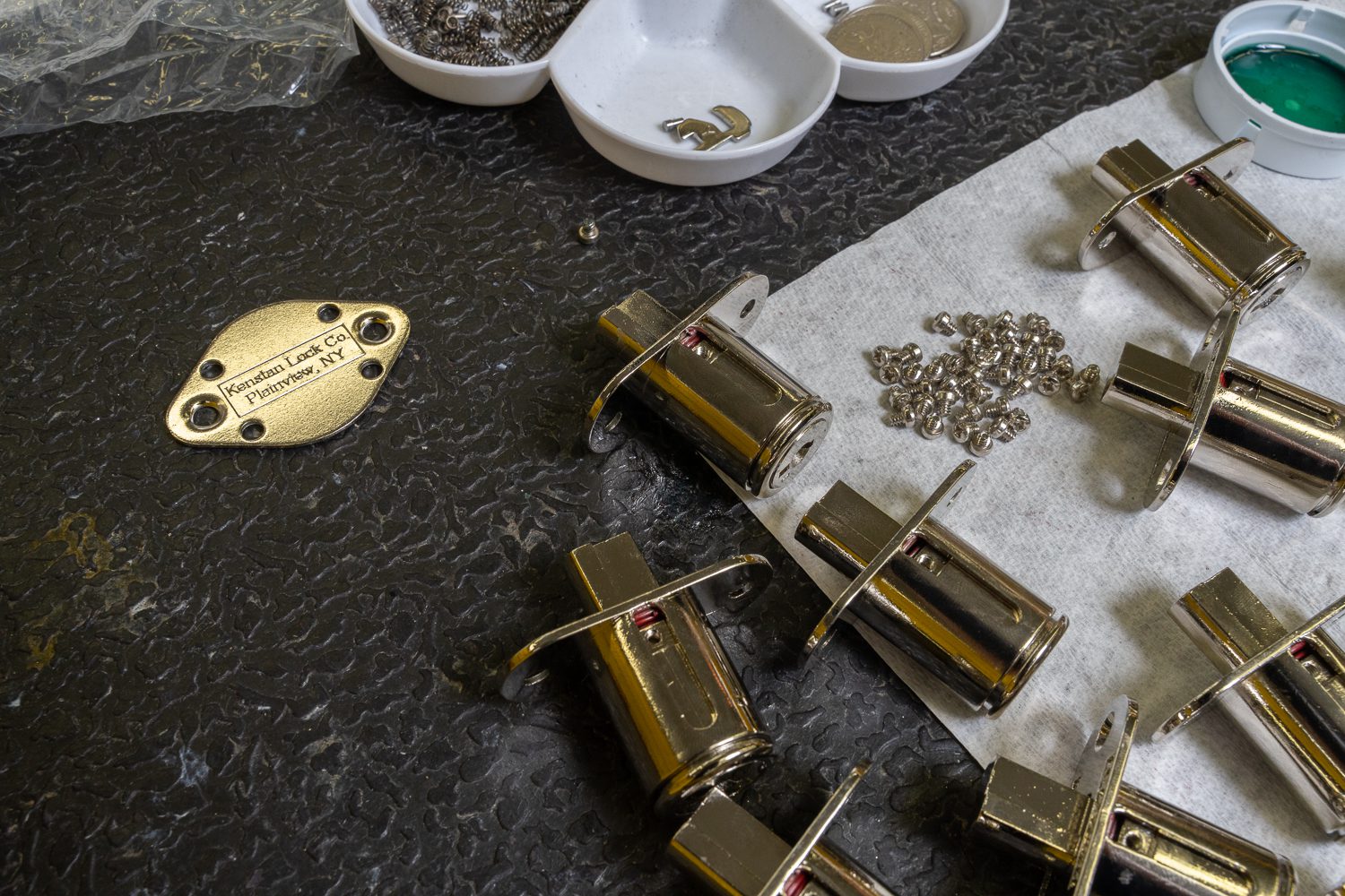 Kenstan Lock Co. lock parts scattered over a work table
