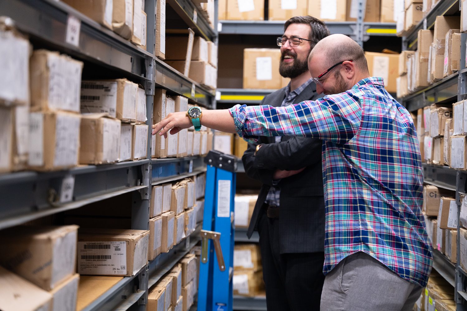 men laughing within storage room photo
